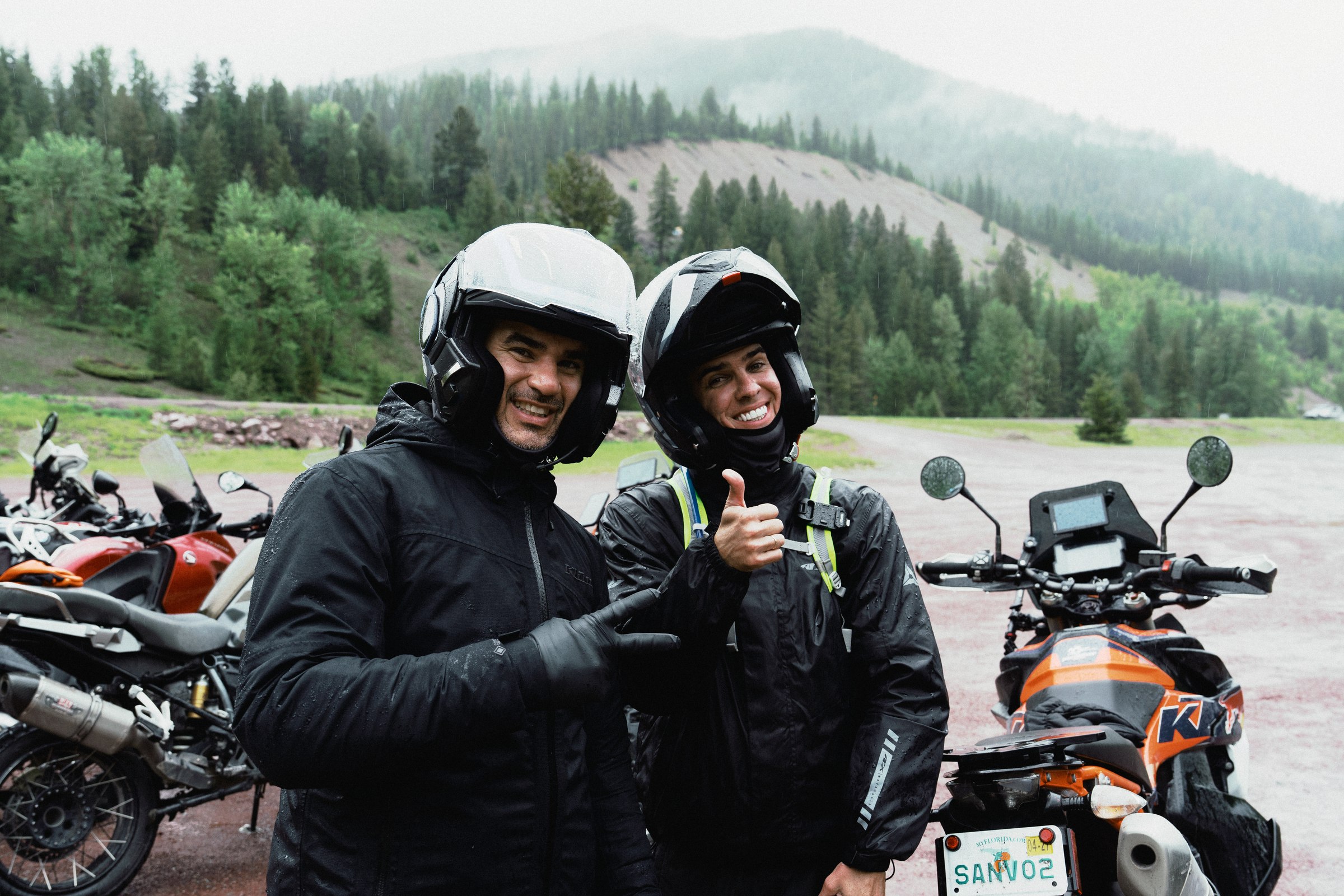 Two riders sharing a laugh in the rain after a ride