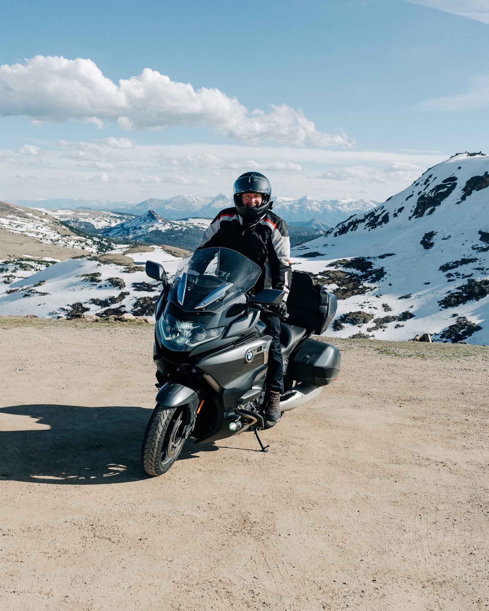 Rider stopped overlooking snow-capped peaks